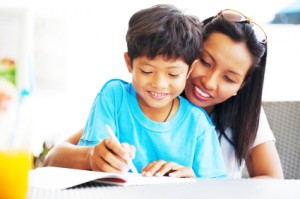 Asian mother helping her son with his homework.